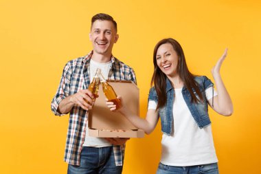 Genç neşeli çift kadın erkek spor fan destek ekibi tungur bira biberon eller üzerinde sarı arka plan izole karton flatbox İtalyan pizza yaymak neşelen. Spor aile yaşam tarzı