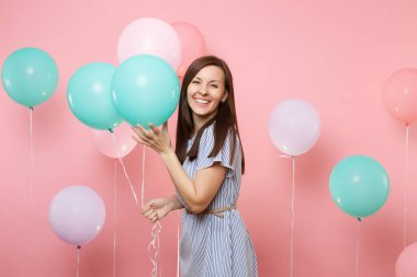 Renkli hava balon pembe parlak eğilimleri üzerinde arka planda tutan mavi çizgili elbise giyen çekici gülümseyen esmer genç kadın portresi. Doğum günü tatil partisi, insanlar samimi duygular kavramı