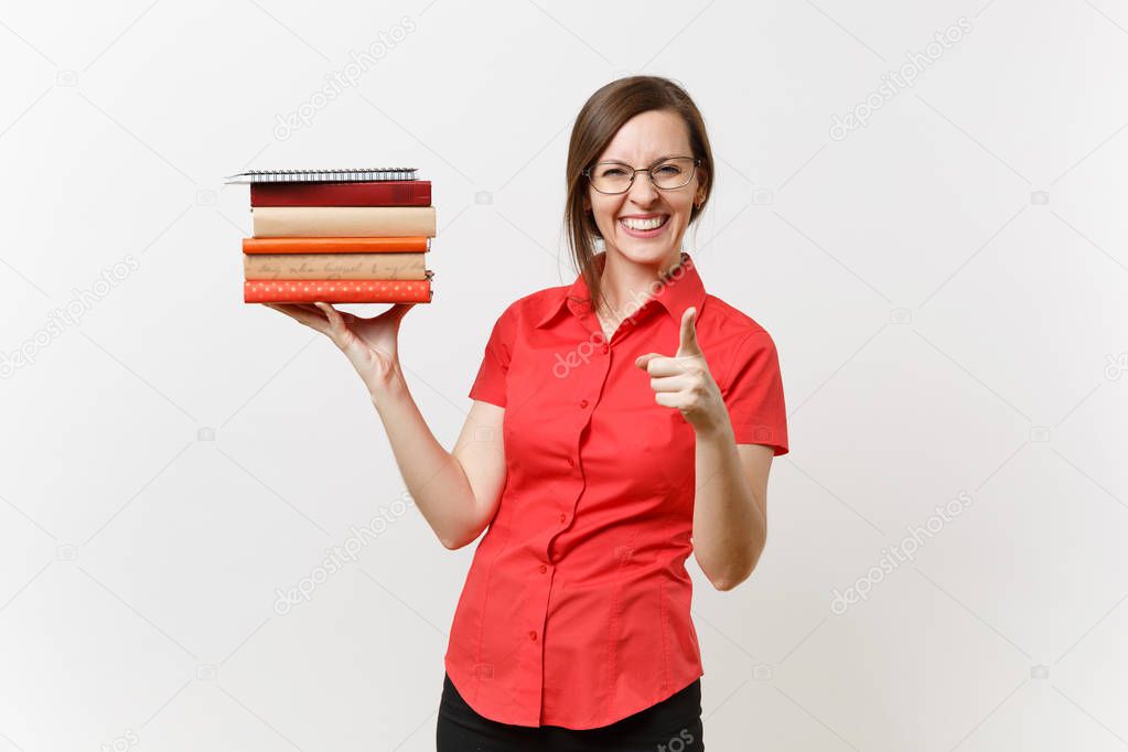 Portrait of beautiful young business teacher woman in red shirt, black skirt and glasses holding books in hands isolated on white background. Education or teaching in high school university concept