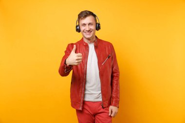 Portre vogue mutlu eğlenceli genç adam kırmızı deri ceket, t-shirt üzerinde arka plan parlak sarı eğilimleri izole kulaklık müzik dinlemek. İnsanlar samimi duygular yaşam tarzı kavramı. Reklam alanı