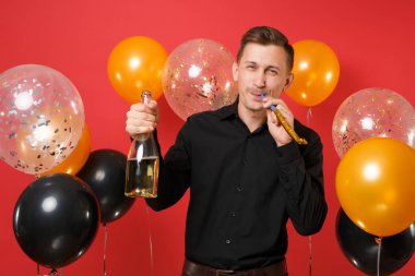 Şişe şampanya kırmızı arka plan hava balonları tutan boru oynama ile siyah klasik gömlek neşeli genç adam. Dünya Kadınlar günü, mutlu yeni yıl, Doğum günü mockup tatil parti konsept
