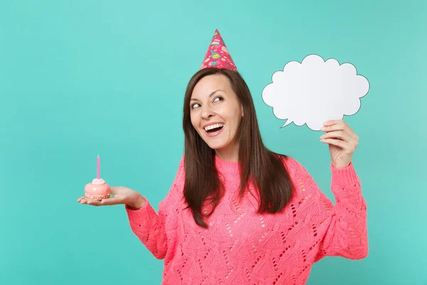 Laughing woman in birthday hat looking up hold cake with candle, empty blank Say cloud, speech bubble for promotional content isolated on blue background. People lifestyle concept. Mock up copy space