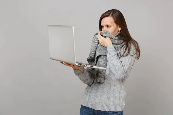 Displeased Young Woman Gray Sweater Covering Mouth Scarf Working Laptop — Stock Photo, Image