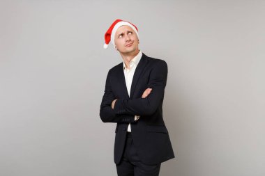 Gri arka plan üzerinde yukarıya bakıp katlanmış elele şapka izole Noel genç iş adamı şaşkın. Başarı kariyer servet iş. Mutlu yeni yıl 2019 kutlama tatil parti konsept
