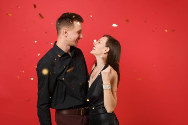 Parlak kırmızı zemin üzerine izole konfeti kadar çarpıcı iki siyah elbiseli Doğum günü tatil partisi kutluyor içinde atmak. St. Valentine's Dünya Kadınlar Günü mutlu yeni yıl 2019 kavramı. Yukarı alay