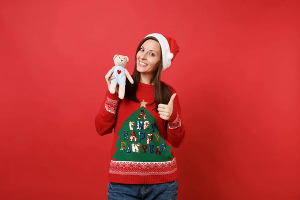 Stunning young Santa girl in Christmas hat showing thumb up, hol — Stock Photo, Image