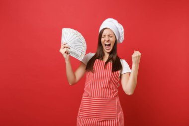 Ev hanımı kadın şef aşçı baker şapkalı izole kırmızı duvar arka plan üzerinde çizgili önlük beyaz t-shirt toque şefler. Dolar banknot bir sürü nakit para tutan heyecanlı kadın. Kopyalama alanı kavramı alay