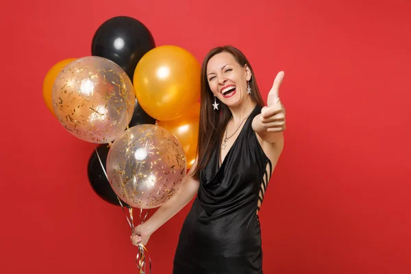 Laughing Young Woman Little Black Dress Showing Thumb Holding Air — Stock Photo, Image