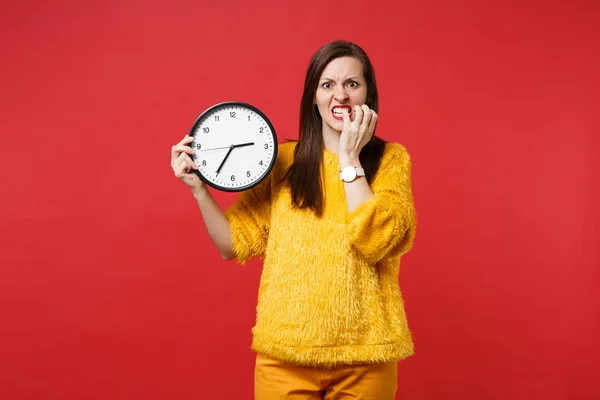 Nervous Young Woman Yellow Fur Sweater Gnawing Nails Holding Clock — Stock Photo, Image