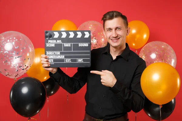 Smiling Young Man Black Shirt Pointing Index Finger Aside Holding — Stock Photo, Image