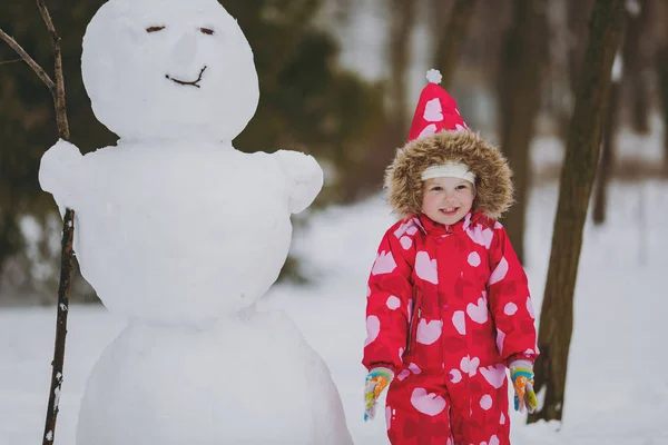 Pretty Little Girl Winter Warm Clothes Hood Playing Standing Snowman — Stock Photo, Image