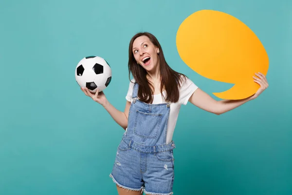 Dreamful woman football fan cheer up support team with soccer ball, empty blank yellow Say cloud, speech bubble isolated on blue turquoise background. People emotions, sport family leisure concept
