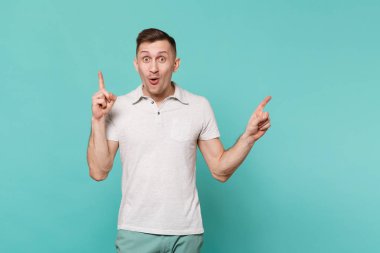 Rahat kıyafetler ile yeni harika fikir, işaret parmağı gidiyor genç adam Tarih bir kenara izole mavi turkuaz renkli işaret heyecanlı. İnsanlar samimi duygular, yaşam kavramı. Kopyalama alanı alay