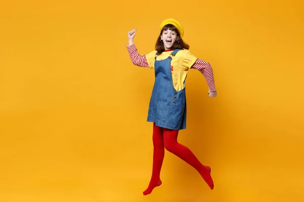 愉快的女孩少年在法国贝雷帽 牛仔太阳礼服传播的手 跳跃和鬼混周围孤立的黄色墙背景上的工作室 人的情感 生活方式的概念 模拟复制空间 — 图库照片
