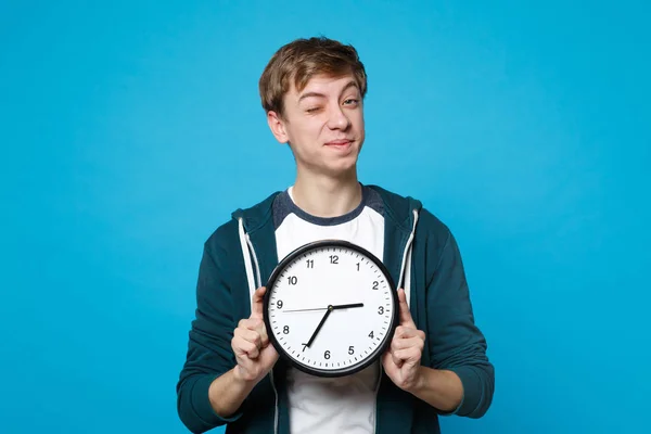 Portrait Funny Young Man Casual Clothes Blinking Holding Clock Isolated — Stock Photo, Image