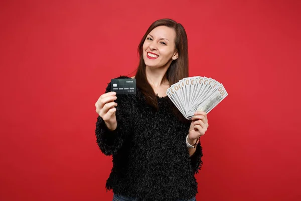 Beautiful young woman in black fur sweater hold credit bank card