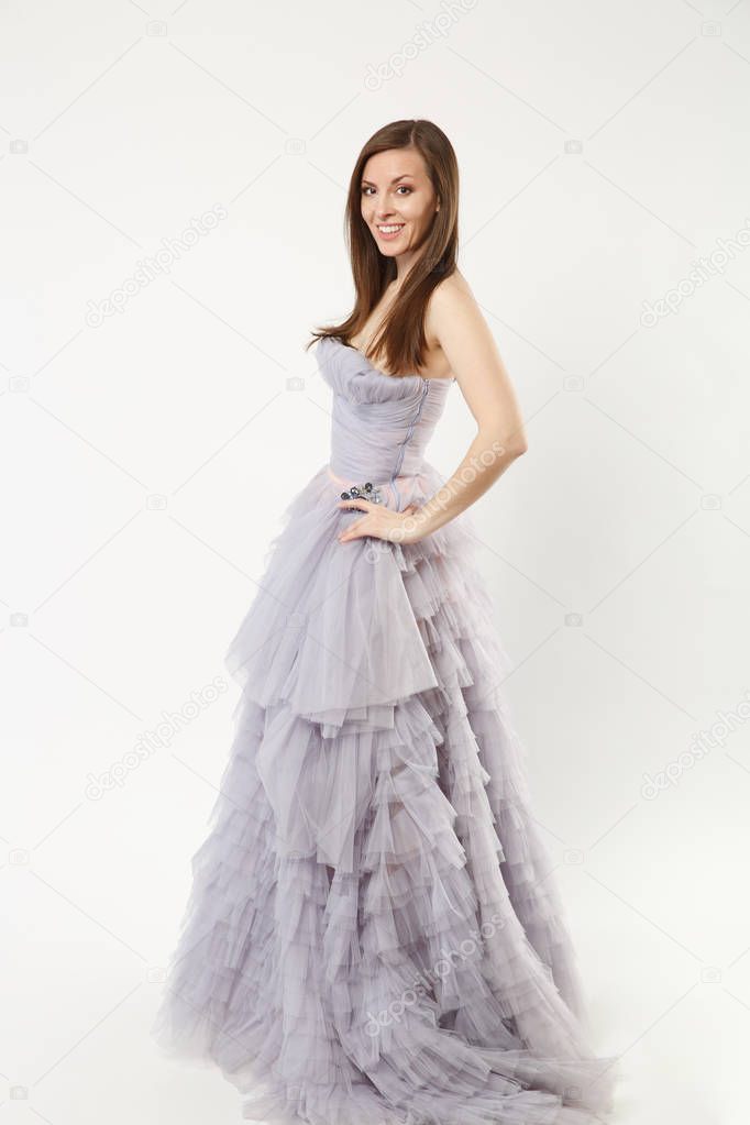 Full length photo fashion model woman wearing elegant evening dress purple gown posing isolated on white wall background studio portrait. Brunette long hair girl. Mock up copy space. Side profile view