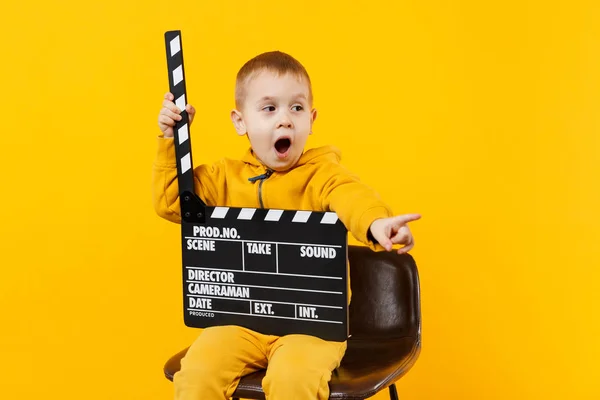 Little kid boy 3-4 years old in yellow clothes isolated on orang — Stock Photo, Image