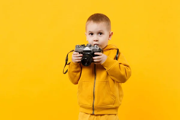 Little kid boy 3-4 years old wearing yellow clothes hold camera