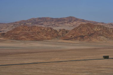 Atacama Çölü, Şili - 18 Ağustos 2017: uzun mesafe Koç Pan Amerikan kuzey Şili'deki Atacama sert ve kurak manzara ile çalışan karayolu (Ruta 5) üzerinde.