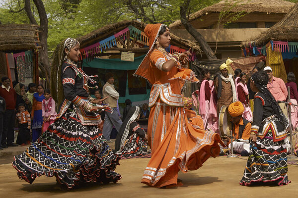 Sarujkund, Haryana, India - February 12, 2009: Kalbelia dancers in ornate costumes trimmed with beads and sequins at the annual Sarujkund Fair near Delhi, India.