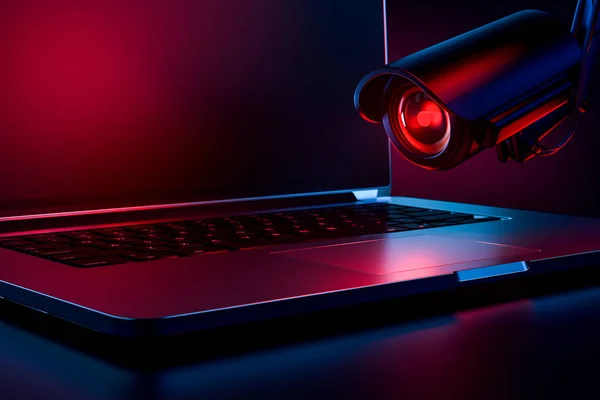 Computer observed by hostile looking camera as a metaphor of stalking or malicious software observing and tracking user. Copy space on laptop screen included. 3D rendering — Stock Photo, Image