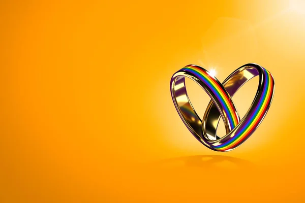 Dos anillos de boda flotantes con colores arcoíris aislados sobre fondo naranja. Movimiento por la igualdad de derechos para los matrimonios gay y el concepto de igualdad de género. Copia el espacio en el lado izquierdo. Renderizado 3D —  Fotos de Stock