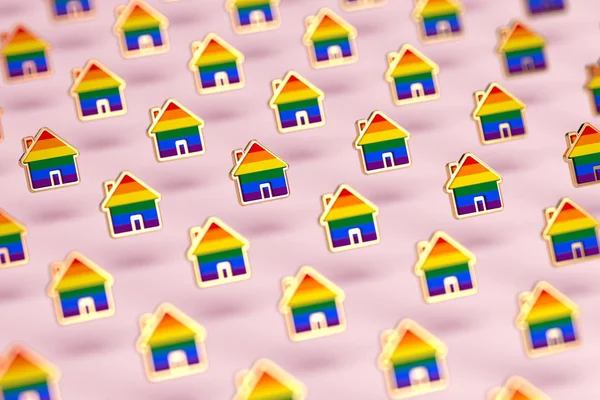 Borroso primer plano en el grupo de arco iris orgullo gay en una forma de hogar aislado sobre fondo rosa pastel. Derechos de las personas LGBTQ a vivir juntos concepto. Renderizado 3D —  Fotos de Stock
