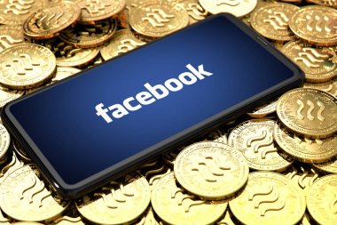 Wroclaw, Polonya - 20 Haziran 2019: Facebook Libra kripto para birimini duyurdu. Ekranda facebook logosu olan akıllı telefon Libra konsept paraların üzerine serili - Görüntü