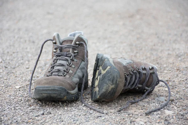 Hiking shoes placed on the street. The beginning of the journey