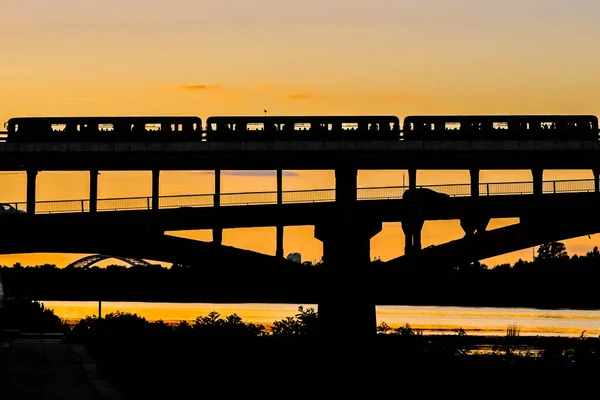 Silhuett Tunnelbanebro Med Ett Passerande Tunnelbanetåg Bakgrund Solnedgång — Stockfoto