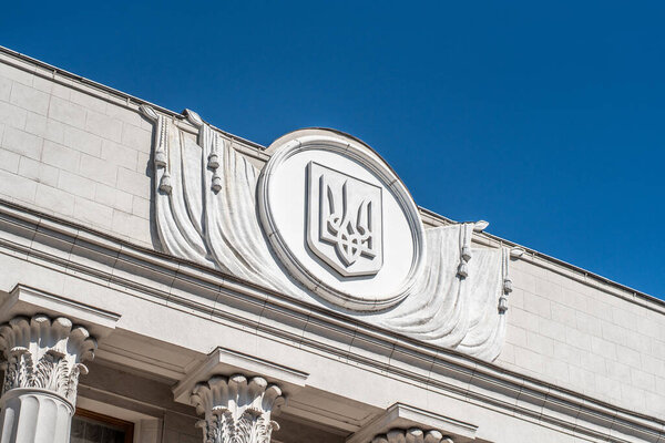 Kyiv, Ukraine - July 17, 2020: Coat of arms of Ukraine trident on the building of the Verkhovna Rada of Ukraine, afternoon, close-up.