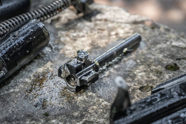 The shutter of the AK 74 submachine gun in disassembled condition during cleaning of the weapon.