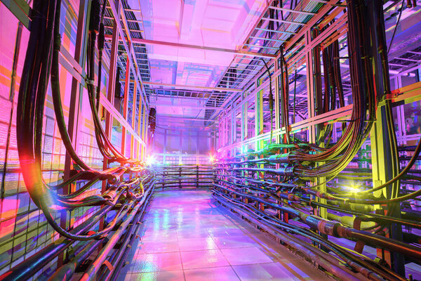 The technical room with many cables is illuminated by multi-colored lights.