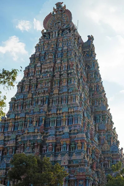 The 9 storey northern Gopuram, or gateway tower, of the Meenakshi temple complex covering 45 acres in the city of Madurai in Tamil Nadu, India. Tamil Nadu is renowned for its Hindu temple structures, and the regional fashion for painting the carvings