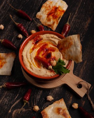Siyah masada kırmızı biberli taze humus.