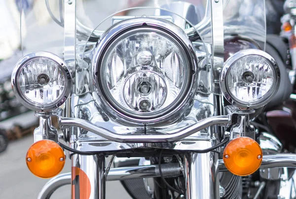 Motorcycle lights. High beam. Dipped beam. Motorcycle cruiser. Chromed motorcycle parts. Front bike plan. Transport background.