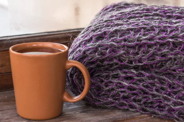 A cup of coffee or tea. Warming drink in winter. Cozy home leisure. Morning espresso with cookies. Knitted background. Relaxing holiday with a cup of cocoa. Comfortable pastime.