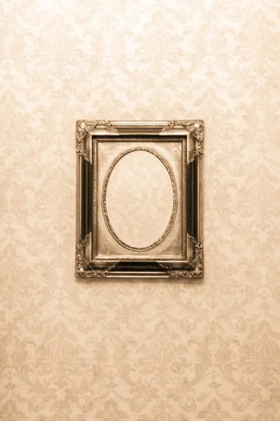 Vintage mirror without reflection. Old mirror in a carved frame. Retro style in the interior. A terrible phot from a horror movie. Empty antique frame.
