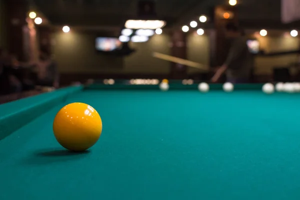 The game of American and Russian billiards. Pool table, ball and cue. Sports leisure. Friendly tournament. Winter fun. Green cloth in billiards. Luza for the ball. Aim and beat. Cue kick.