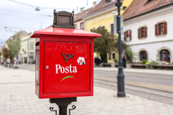 Red mailbox. Europe Post. Old-fashioned communications. Traditional mail. Write letters. Send a message. Box for letters and postcards. City mail. Way of communication. Keep in touch.
