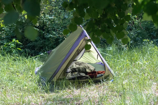 Green tourism. Rest in the mountains or the forest. Wildlife in the tent. Camping for summer holidays. Weekend camp in nature. Travel with a backpack. Rest in solitude.