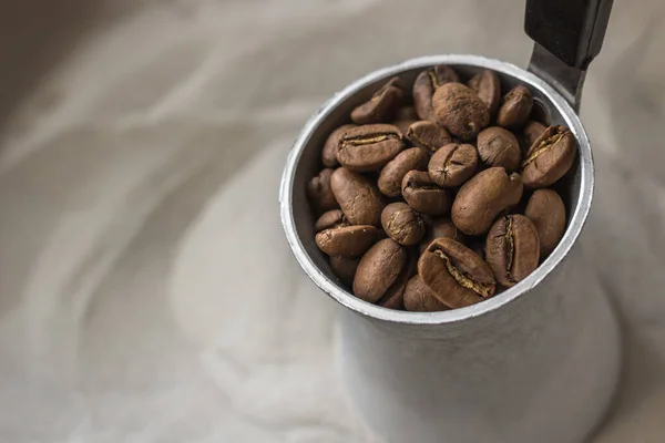 Coffee beans. Coffee in a Turk on the sand. Background for coffee shop, cafe and restaurant. An invigorating aromatic drink. Morning espresso. Caffeine benefits and harms. Turkish coffee for breakfast.