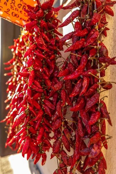 Dried red spicy peppers hanging on a street stall in the south of Italy. A typical and traditional product in Calabria