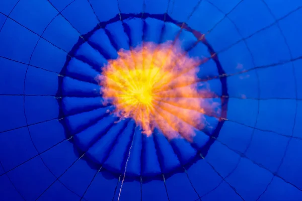 Inside a blue hot air balloon. fire from a gas burner inside a hot air balloon
