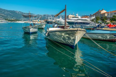Budva 'daki körfezde demirlemiş küçük ahşap kayıklar.