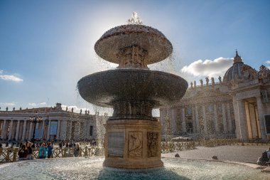 A beautiful, historic fountain in St. Peter in the Vatican, Beautiful sunny day, many tourists. Italy, Europe