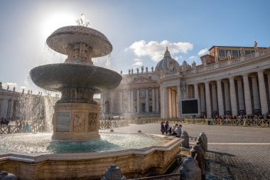 Monuments on St. Peter in the Vatican. A huge fountain in the foreground and St. Peter's Basilica in the distance, Italy.
