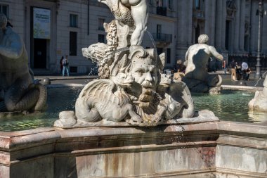 Beautifully carved fountains and the cathedral in Piazza Navona in Rome. Sunny summer day. Italy, Europe