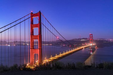 The Golden Gate, suspension bridge spanning the strait of the same name, is seen just before dawn from Battery Spencer, an old gun emplacement on the Marin Headlands that protected from enemy invasion in years past. clipart